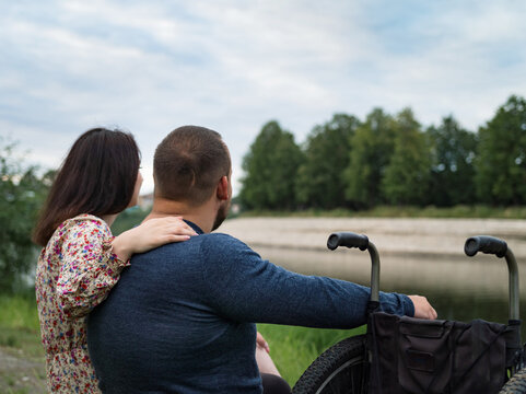 Girlfriend hugs boyfriend man by the river