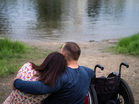 Man hugging woman  by the river 