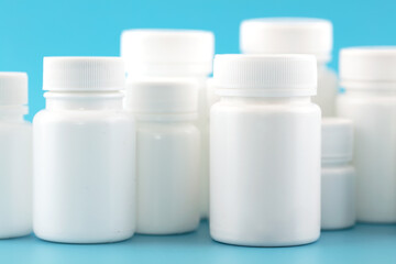 White medicine bottle on blue background
