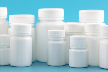 White medicine bottle on blue background