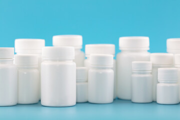 White medicine bottle on blue background