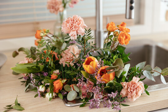 Bouquet of flowers in sink in apartment