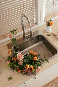 Bunch of flowers in sink in kitchen