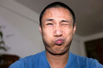 Asian father making funny faces

