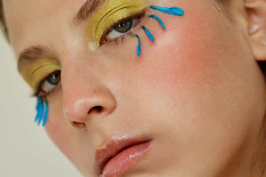 Close-up of a young woman with creative makeup