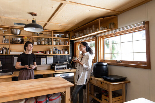 Two Employees Chat In Cafe