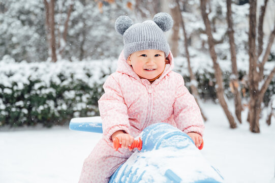 Cute baby playing in snowy day