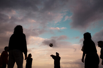 Group of friends playing beach volley