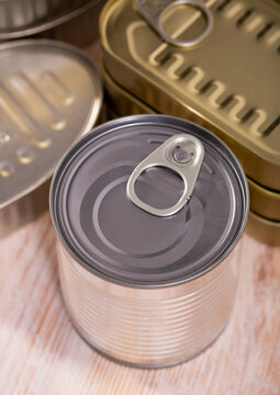 Close up of unlabeled yellow and silver tin cans