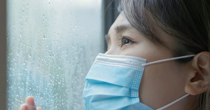 Woman Look Through Rainy Window