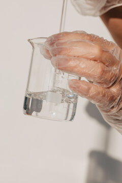 Anonymous scientist mixing liquid in Beaker 
