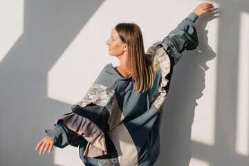 Carefree woman in oversized outfit in studio
