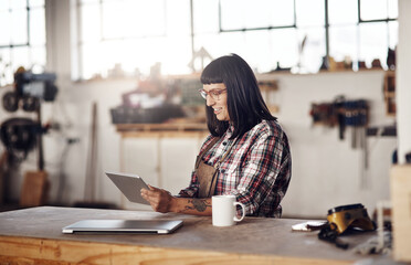 Custom designs are what shes all about. Cropped shot of an attractive young woman working on her...