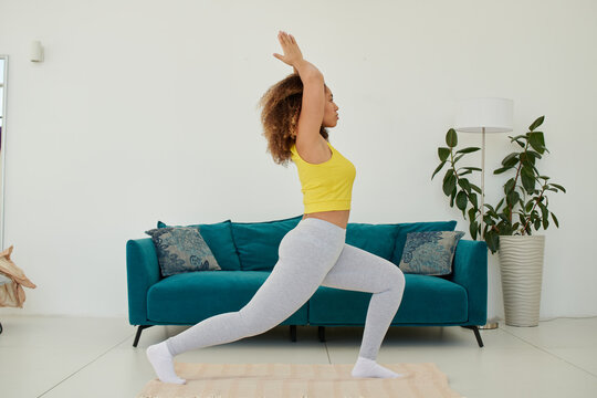young woman keep balance, stand on one leg