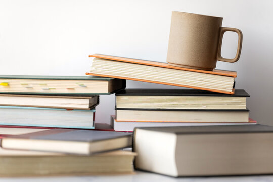 Coffee mug resting on stack of books