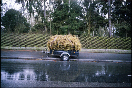 Car trailer with kindling parked on the street