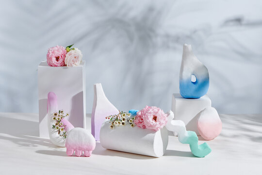 Stylish ceramic vases on white table
