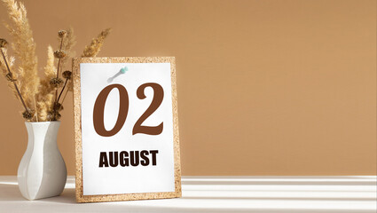 august 2. 2th day of month, calendar date.White vase with dead wood next to cork board with numbers. White-beige background with striped shadow. Concept of day of year, time planner, summer month