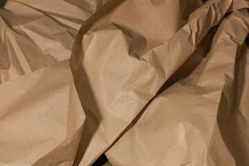 Roughly crumpled beige craft paper, close-up. Art concept, idea for creativity and design. Background or texture