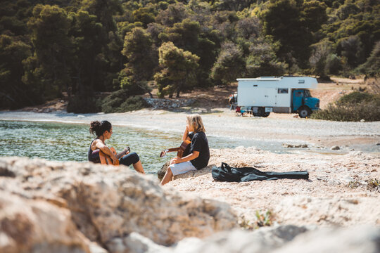family making music at the beach