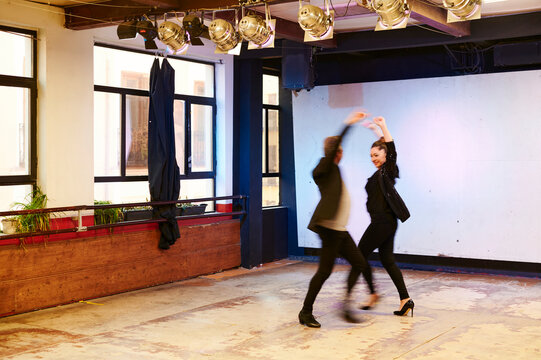 Smiling flamenco dancers in blurred motion
