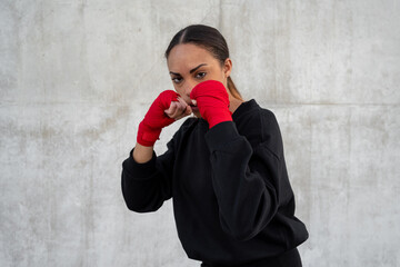 Serious sportswoman in fighting stance during workout