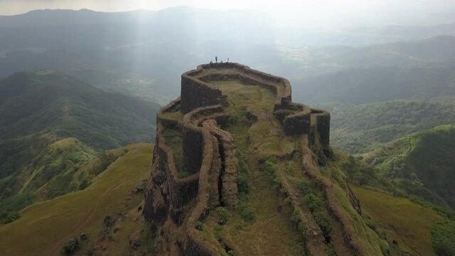 Amazing aerial sun rays view of remote green valleys from Zunjar Machi