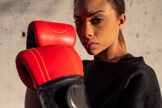 Determined boxer in fighting pose in city