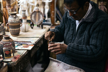 Senior ceramic artist at work