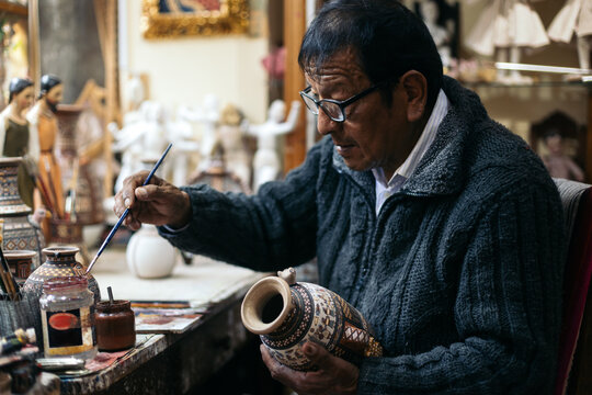 Senior ceramic artist working in his workshop