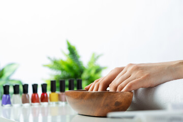 Woman hands in wooden bowl with water