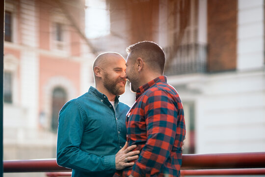 Content gay couple cuddling in city