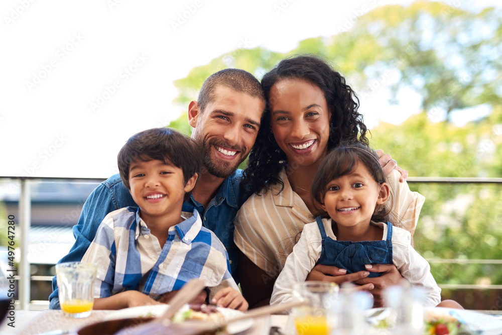 Sticker Love is the glue that keeps us all together. Portrait of a beautiful young family enjoying a meal together outdoors.