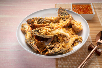 Fried Flathead lobster or Mantis shrimp fried with Garlic and Pepper Served with chili, lime, spicy sauce  , Seafood dish.