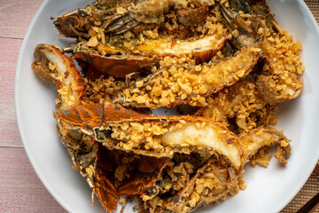 Fried Flathead lobster or Mantis shrimp fried with Garlic and Pepper Served with chili, lime, spicy sauce  , Seafood dish.