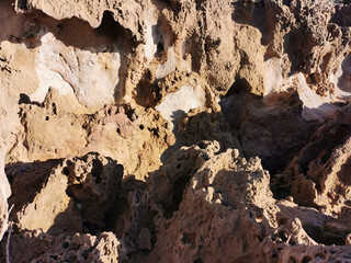 Long frozen lava, porous shore of the Mediterranean Sea.