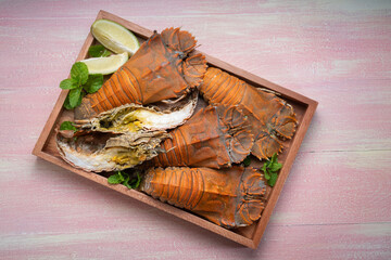 Flathead lobster on wooden background, Flathead lobster or Mantis shrimp on wooden plate ready to eat, Seafood dish.