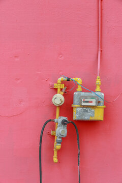 Pink wall and yellow gas meter.