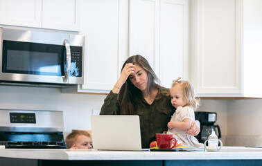 Tired Mother Trying To Work With Children