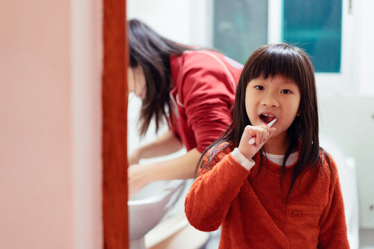 little girl brushing her teeth