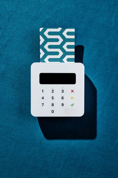 wireless payment terminal on blue velvet