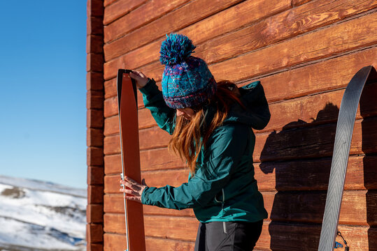 Alpinist preparing skis for climbing in mountains
