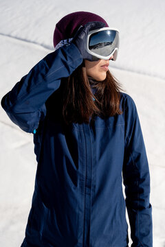Woman in ski glasses in snowy highlands