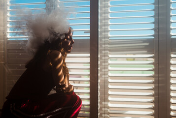 Relaxed woman with smoke cloud on her head