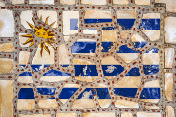 National flag of Uruguay  on stone  wall background. Flag  banner on  stone texture background.