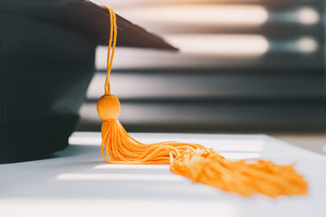 lack graduation cap university level and a notebook on a wooden table, graduation concept