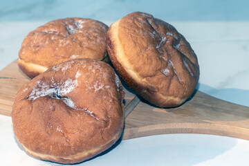 Jewish holiday Hanukkah background. A traditional dish is sweet donuts. Copy space.