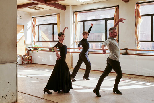 Flamenco teacher and students dancing in a class