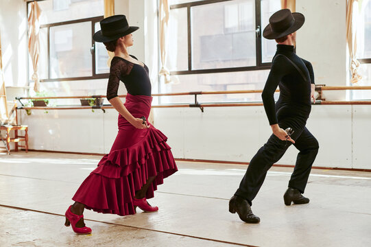 Flamenco performers dancing in traditional clothes