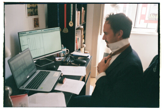 Man learning to make a tie knot online tutorial